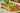The image shows colorful vegetable skewers with carrot, bell pepper, tomato, zucchini, and red onion.