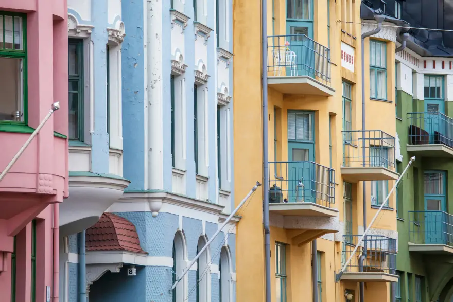 Buildings of different colors side by side in a streetscape.